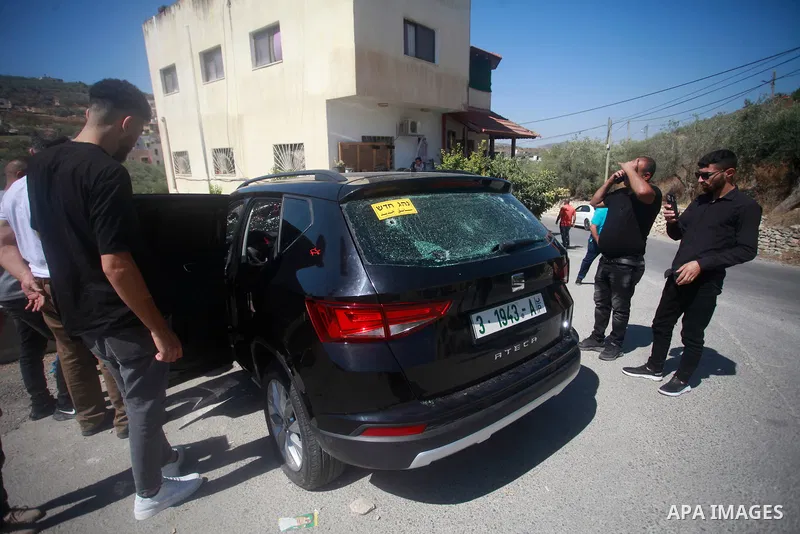 Palestinians stand next to a bullet-ridden car in which a Palestinian was killed late by Israeli forces, in an incident described by the army as a "car ramming attempt" in the town of Sebastia near Nablus in the West Ban...