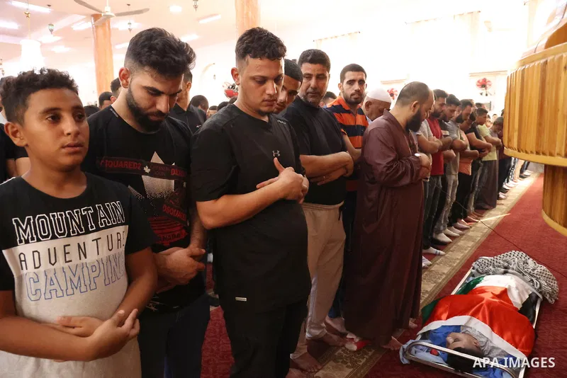 Mourners carry the body of Palestinian, Qusai al-Walaji, who was killed in an Israeli raid, during his funeral in the West Bank city of Jericho on August 15, 2023. Two Palestinians, including a minor, were early Tuesday...