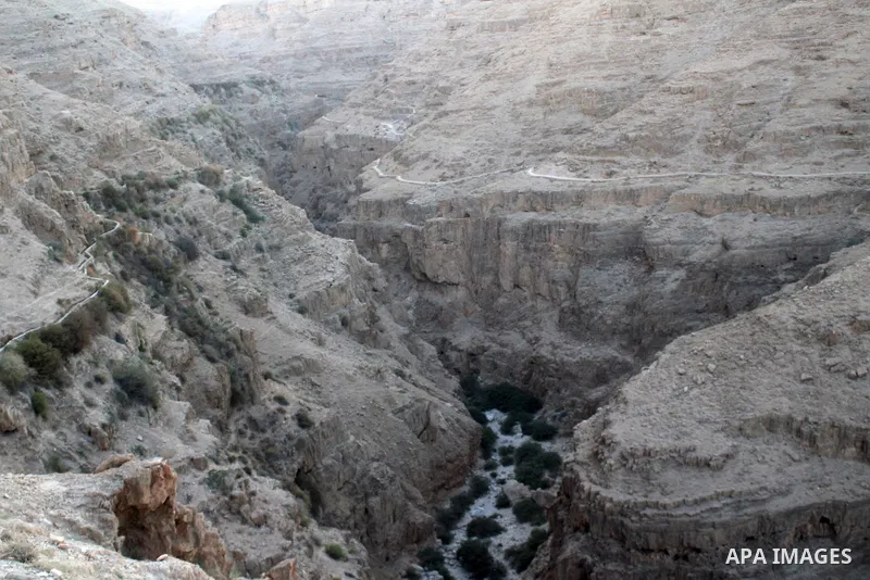 Monastery of Saints George or Wadi Qelt are seen in the desert between Jerusalem and Jericho on August 27, 2023. St. George's Monastery is a Greek Orthodox cliff-hanging complex carved into a sheer rock wall in the Judae...