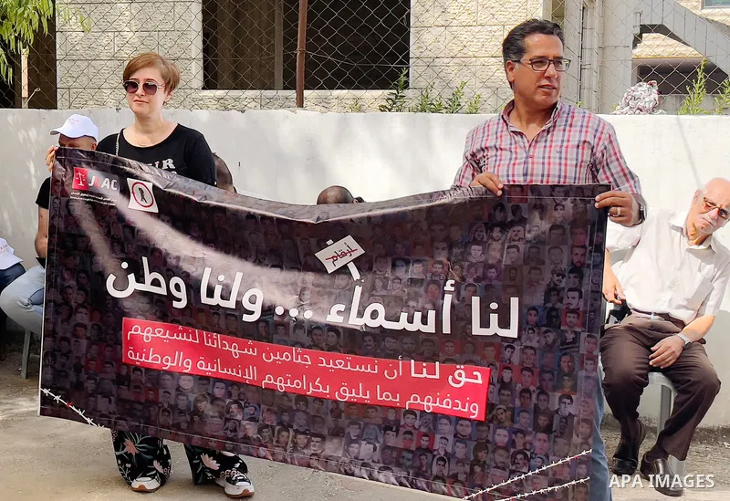 Palestinians take part in a protest to demand the return of the bodies of their slain relatives held by Israeli forces, in front of Red cross office in the West Bank city of Ramallah on August 29, 2023. Israeli authoriti...