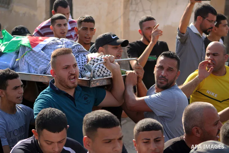 Palestinians carry the body of Dhargham Al-Akhras, 19, during his funeral in the refugee camp of Aqabat Jabr in the West Bank city of Jericho on September 20, 2023. Israeli forces Wednesday morning shot and killed a Pale...