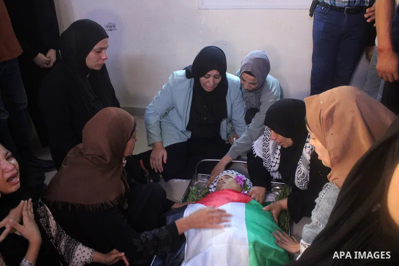 Palestinians carry the body of Dhargham Al-Akhras, 19, during his funeral in the refugee camp of Aqabat Jabr in the West Bank city of Jericho on September 20, 2023. Israeli forces Wednesday morning shot and killed a Pale...