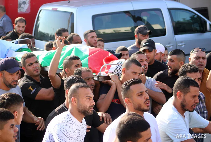 Palestinians carry the body of Dhargham Al-Akhras, 19, during his funeral in the refugee camp of Aqabat Jabr in the West Bank city of Jericho on September 20, 2023. Israeli forces Wednesday morning shot and killed a Pale...