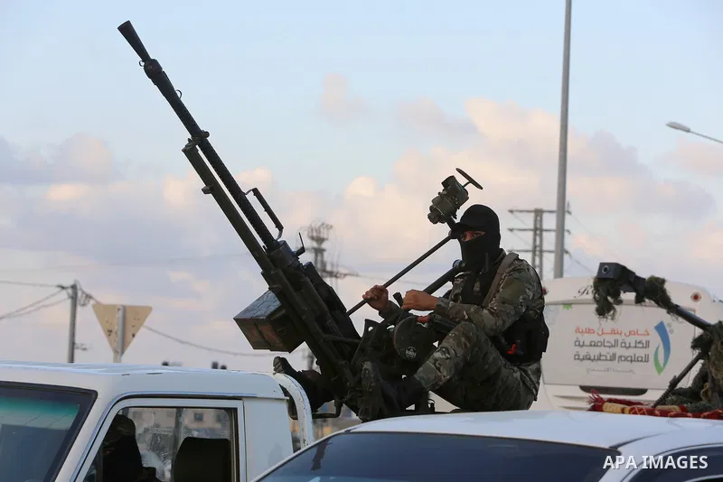 Palestinians and militants from the Palestinian factions participate in the opening of the memorial commemorating the 18th anniversary of the Israeli withdrawal from the Gaza Strip near the Rafah crossing, in the souther...