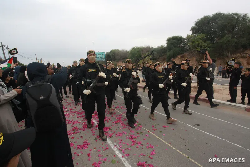 Fighters of the Al-Quds Brigades, the military wing of the Islamic Jihad movement in Palestine, participate in a military parade on the occasion of the movement’s 36th launch, in the central Gaza Strip on October 4, 2023...