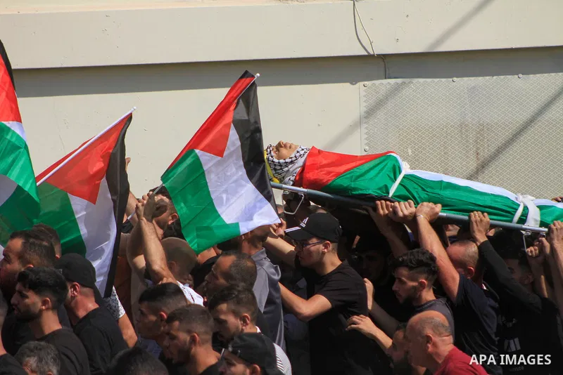 Palestinians carry the body of 19-year-old Labib Damidi, who was shot in an overnight attack in the village of Huwara village, in nablus city, West Bank , on October 6, 2023.The Palestinian health ministry said. "Labib M...