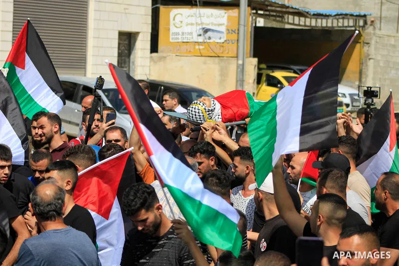 Palestinians carry the body of 19-year-old Labib Damidi, who was shot in an overnight attack in the village of Huwara village, in nablus city, West Bank , on October 6, 2023.The Palestinian health ministry said. "Labib M...