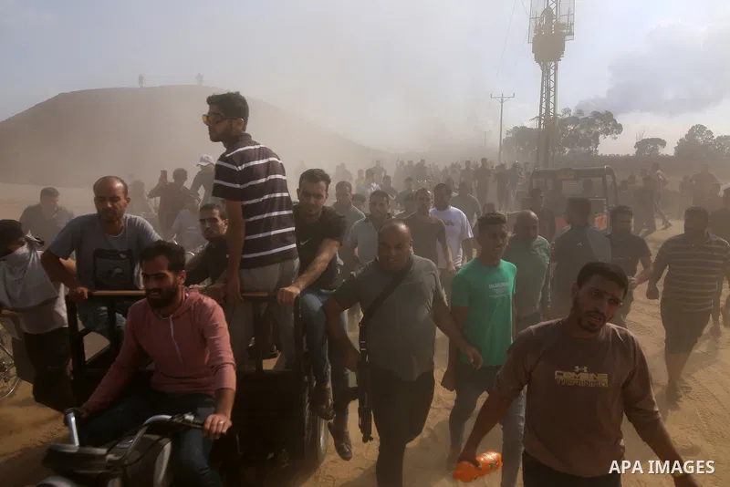 People run as the clashes between Palestinian groups and Israeli forces continue in Gaza City, Gaza on October 7, 2023. Photo by STR\ apaimages
