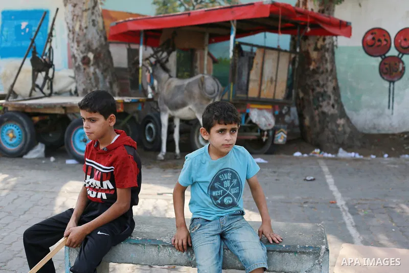 Palestinians fleeing Israeli air strikes take refuge in a school run by the United Nations in Gaza city, on October 8, 2023. Fighting between Israeli forces and the Palestinian militant group Hamas raged on October 8, wi...