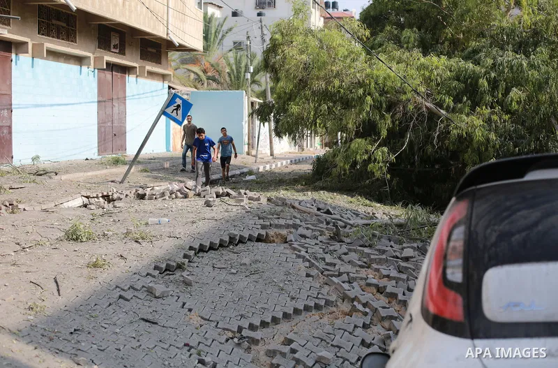 Palestinians inspect the ruins of a school destroyed in Israeli airstrikes in Gaza city, on October 8, 2023. Fighting between Israeli forces and the Palestinian militant group Hamas raged on October 8, with hundreds kill...