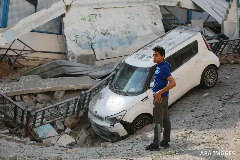Palestinians inspect the ruins of a school destroyed in Israeli airstrikes in Gaza city, on October 8, 2023. Fighting between Israeli forces and the Palestinian militant group Hamas raged on October 8, with hundreds kill...