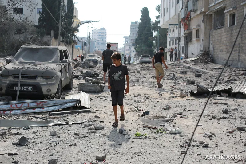 Palestinians inspect the ruins of a school destroyed in Israeli airstrikes in Gaza city, on October 8, 2023. Fighting between Israeli forces and the Palestinian militant group Hamas raged on October 8, with hundreds kill...
