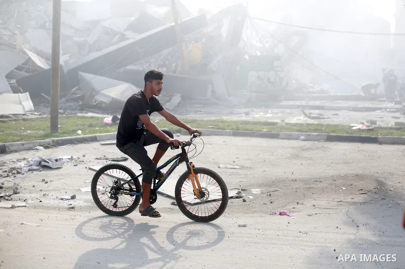 Palestinians inspect the ruins of Watan Tower destroyed in Israeli airstrikes in Gaza city, on October 8, 2023. Fighting between Israeli forces and the Palestinian militant group Hamas raged on October 8, with hundreds k...