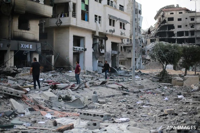 Palestinians inspect the damage following an Israeli airstrike on the El-Remal aera in Gaza City on October 9, 2023. Israel continued to battle Hamas fighters on October 10 and massed tens of thousands of troops and heav...
