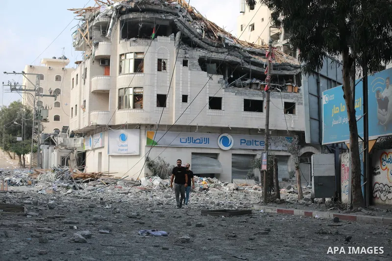 Palestinians inspect the damage following an Israeli airstrike on the El-Remal aera in Gaza City on October 9, 2023. Israel continued to battle Hamas fighters on October 10 and massed tens of thousands of troops and heav...
