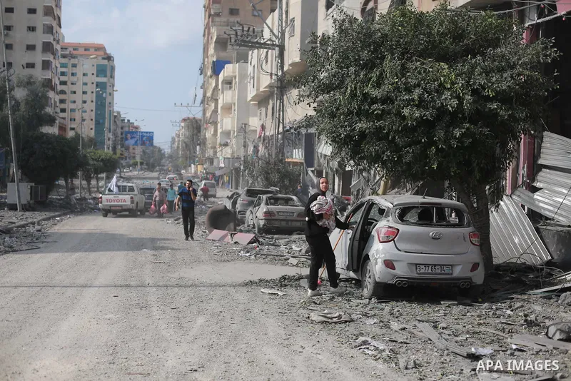 Palestinians inspect the damage following an Israeli airstrike on the El-Remal aera in Gaza City on October 9, 2023. Israel continued to battle Hamas fighters on October 10 and massed tens of thousands of troops and heav...
