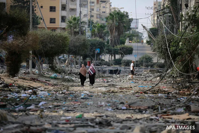 Palestinians inspect the damage following an Israeli airstrike on the El-Remal aera in Gaza City on October 9, 2023. Israel continued to battle Hamas fighters on October 10 and massed tens of thousands of troops and heav...