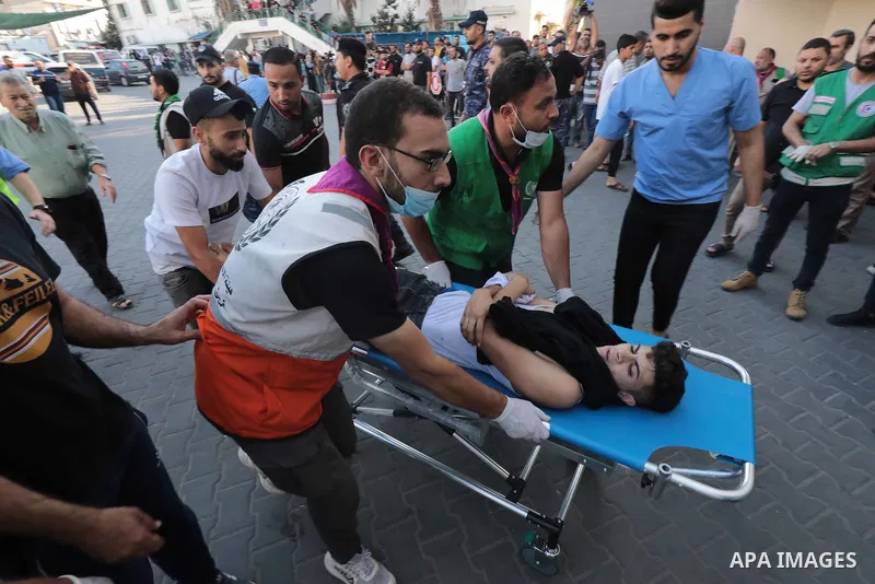 Medics transport wounded children into at al-Shifa hospital following Israeli strikes in Gaza City on October 10, 2023. Israel said it recaptured Gaza border areas from Hamas as the war's death toll passed 3,000 on Octob...