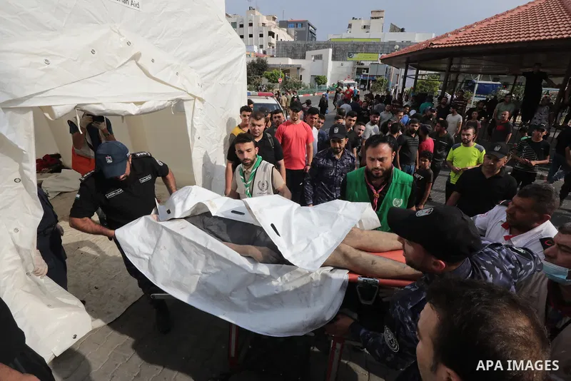 Medics transport wounded children into at al-Shifa hospital following Israeli strikes in Gaza City on October 09, 2023. Israel said it recaptured Gaza border areas from Hamas as the war's death toll passed 3,000 on Octob...