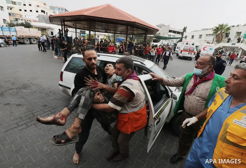 Medics transport wounded man into at al-Shifa hospital following Israeli strikes in Gaza City on October 09, 2023. Israel said it recaptured Gaza border areas from Hamas as the war's death toll passed 3,000 on October 10...