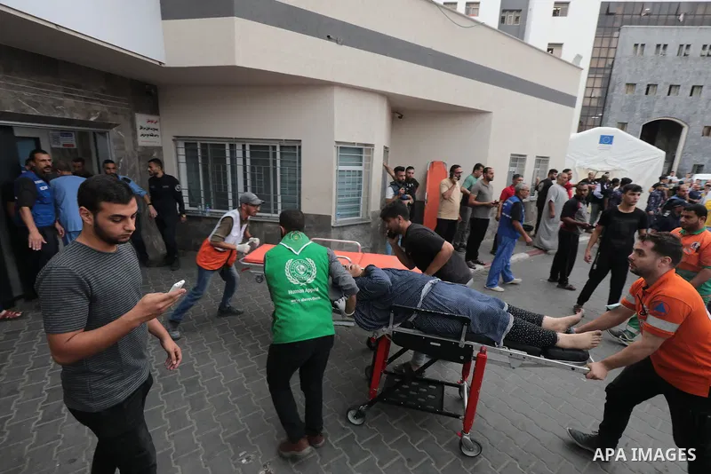 Medics transport wounded woman into at al-Shifa hospital following Israeli strikes in Gaza City on October 09, 2023. Israel said it recaptured Gaza border areas from Hamas as the war's death toll passed 3,000 on October...