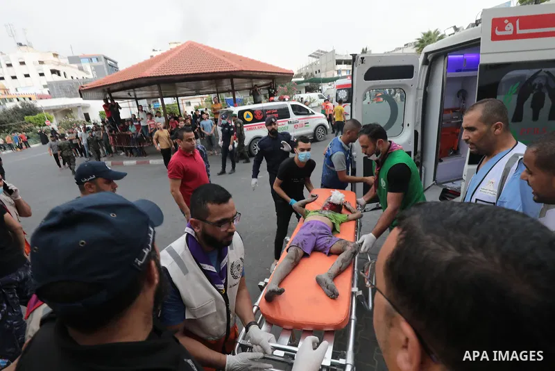 Medics transport wounded children into at al-Shifa hospital following Israeli strikes in Gaza City on October 09, 2023. Israel said it recaptured Gaza border areas from Hamas as the war's death toll passed 3,000 on Octob...