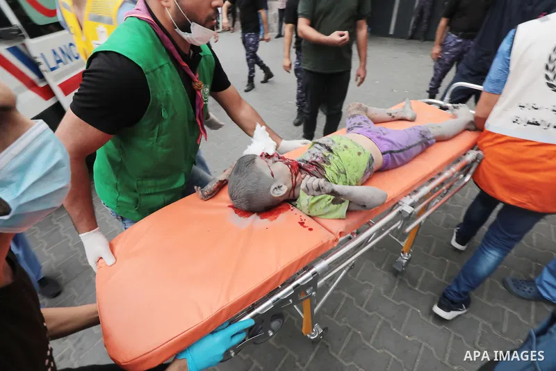 Medics transport wounded children into at al-Shifa hospital following Israeli strikes in Gaza City on October 09, 2023. Israel said it recaptured Gaza border areas from Hamas as the war's death toll passed 3,000 on Octob...