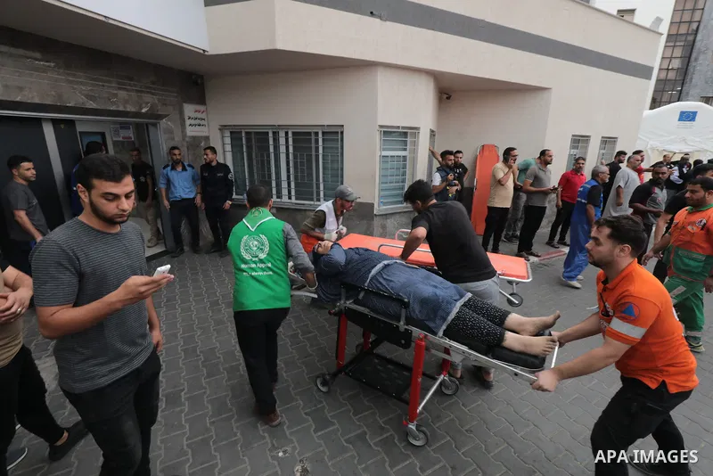 Medics transport wounded woman into at al-Shifa hospital following Israeli strikes in Gaza City on October 09, 2023. Israel said it recaptured Gaza border areas from Hamas as the war's death toll passed 3,000 on October...