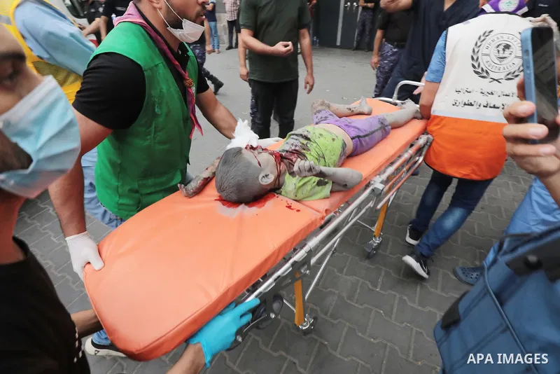 Medics transport wounded children into at al-Shifa hospital following Israeli strikes in Gaza City on October 09, 2023. Israel said it recaptured Gaza border areas from Hamas as the war's death toll passed 3,000 on Octob...