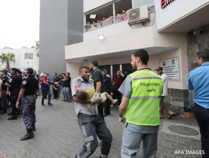 Medics transport wounded children into at al-Shifa hospital following Israeli strikes in Gaza City on October 09, 2023. Israel said it recaptured Gaza border areas from Hamas as the war's death toll passed 3,000 on Octob...