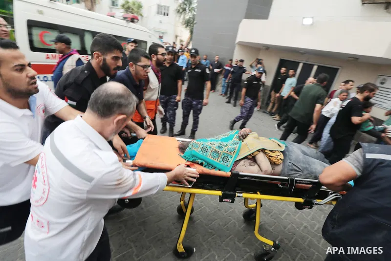 Medics transport wounded children into at al-Shifa hospital following Israeli strikes in Gaza City on October 09, 2023. Israel said it recaptured Gaza border areas from Hamas as the war's death toll passed 3,000 on Octob...