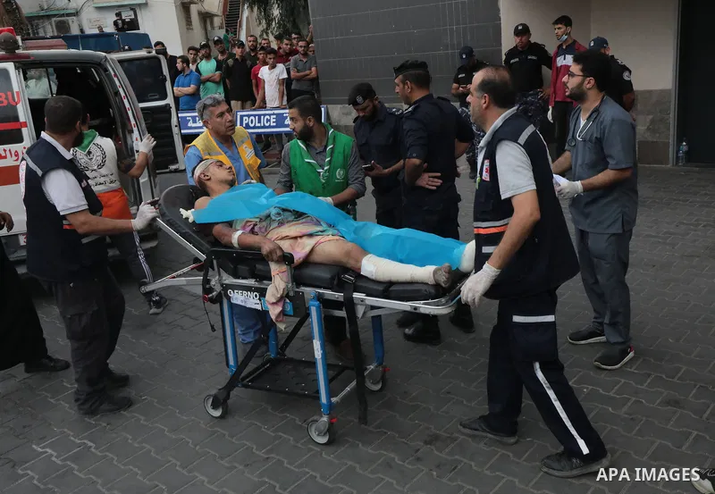 Medics transport wounded man into at al-Shifa hospital following Israeli strikes in Gaza City on October 09, 2023. Israel said it recaptured Gaza border areas from Hamas as the war's death toll passed 3,000 on October 10...