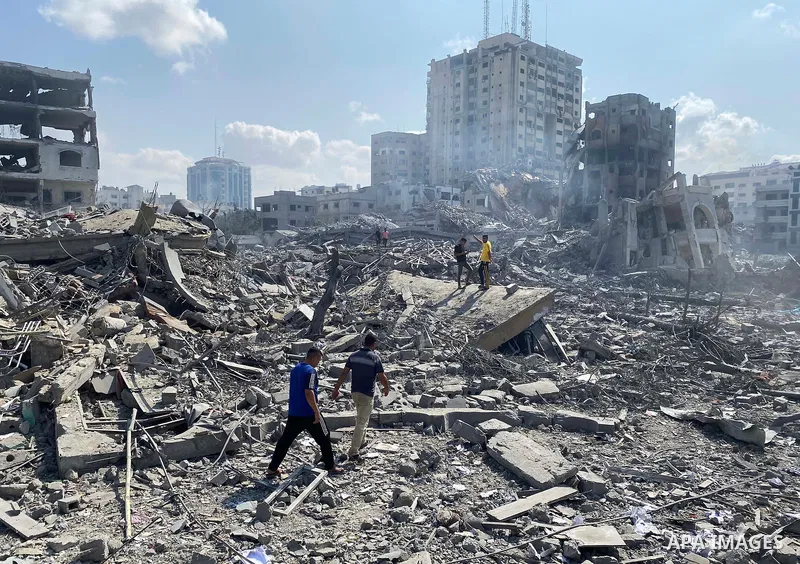 Palestinians inspect the damage following an Israeli airstrike on the El-Remal aera in Gaza City on October 9, 2023. Israel continued to battle Hamas fighters on October 10 and massed tens of thousands of troops and heav...