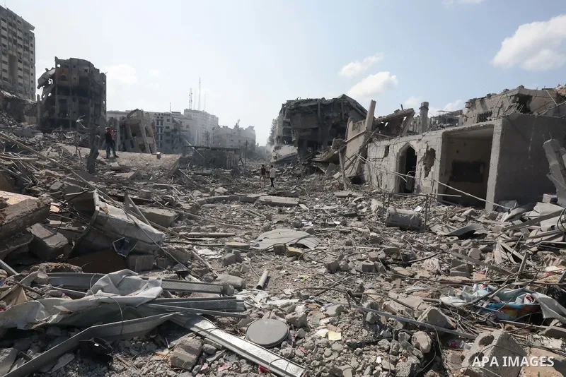 Palestinians inspect the damage following an Israeli airstrike on the El-Remal aera in Gaza City on October 9, 2023. Israel continued to battle Hamas fighters on October 10 and massed tens of thousands of troops and heav...