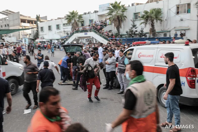 Medics transport an injured Palestinian child into Al-Shifa hospital in Gaza City following an Israeli airstrike on October 11, 2023, as raging battles between Israel and the Hamas movement continued for the fifth consec...