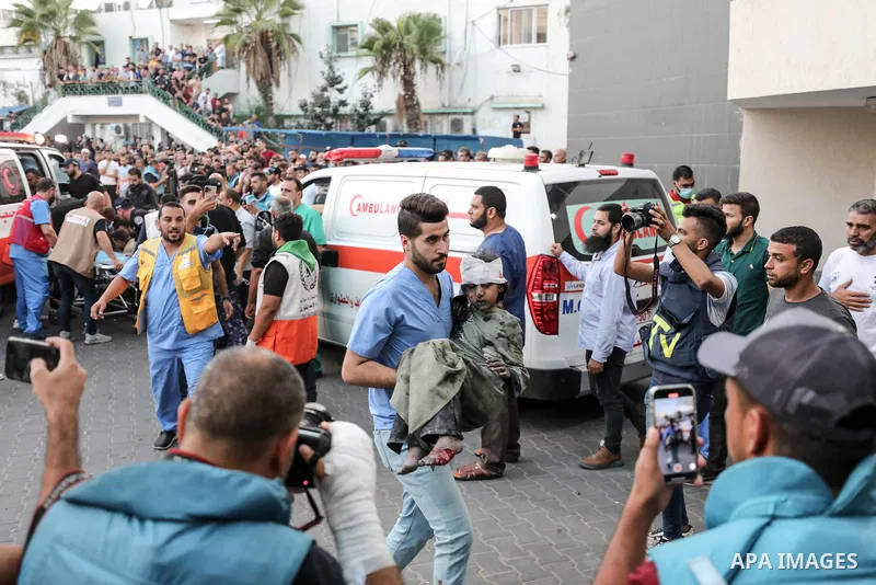 Medics transport an injured Palestinian child into Al-Shifa hospital in Gaza City following an Israeli airstrike on October 11, 2023, as raging battles between Israel and the Hamas movement continued for the fifth consec...