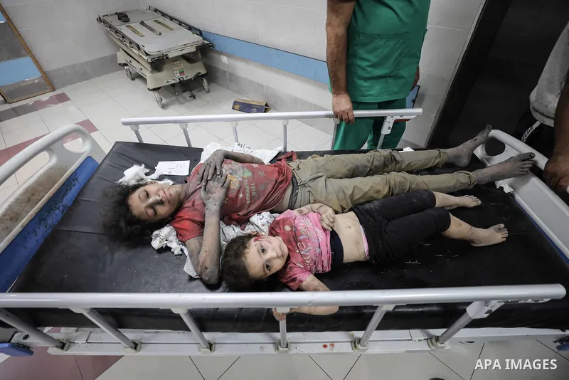 Wounded Palestinians wait for treatment at the overcrowded emergency ward of Al-Shifa hospital in Gaza City following an Israeli airstrike on October 11, 2023, as raging battles between Israel and the Hamas movement cont...