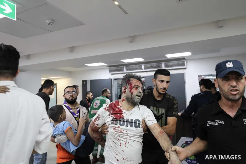 Medics transport an injured Palestinian Man into Al-Shifa hospital in Gaza City following an Israeli airstrike on October 11, 2023, as raging battles between Israel and the Hamas movement continued for the fifth consecut...