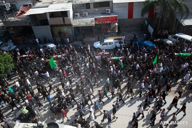 Mourners carry the bodies of six Palestinians, killed in a raid by Israeli troops, during their funeral in the town of Tulkarm in the north of the occupied West Bank on October 20, 2023. The death toll from a raid by Isr...