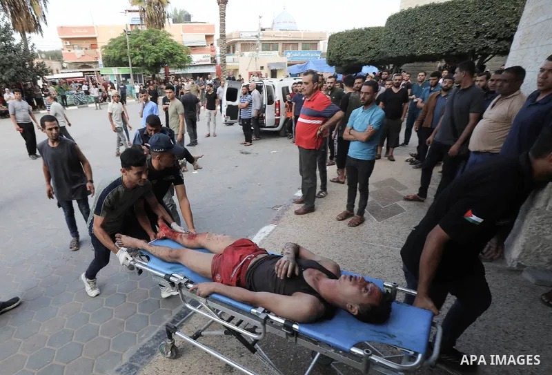Medics transport wounded Palestinians (includ children) at a hospital following an Israeli air strike in Dair El-Balah refugues camp, in the central Gaza Strip on October 31, 2023, amid the ongoing battles between Israel...