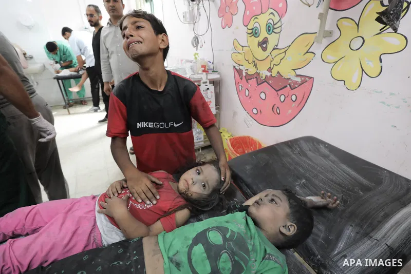 Medics transport wounded Palestinians (includ children) at a hospital following an Israeli air strike in Dair El-Balah refugues camp, in the central Gaza Strip on October 31, 2023, amid the ongoing battles between Israel...