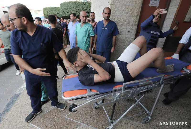 Medics transport wounded Palestinians (includ children) at a hospital following an Israeli air strike in Dair El-Balah refugues camp, in the central Gaza Strip on October 31, 2023, amid the ongoing battles between Israel...