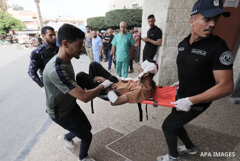 Medics transport wounded Palestinians (includ children) at a hospital following an Israeli air strike in Dair El-Balah refugues camp, in the central Gaza Strip on October 31, 2023, amid the ongoing battles between Israel...