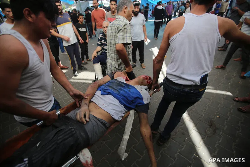 Palestinians men carrying a man enters the Al-Shifa hospital following the Israeli bombardment of Gaza City's Mansura neighbourhood, in the eastern suburb of Shujaiya on November 4, 2023, amid the ongoing battles between...
