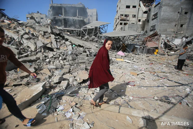 People search through buildings, destroyed during Israeli air raids on Al-Shati refugee camp in Gaza City on November 6, 2023. The Israeli army has expanded its military assault. The Gaza strip, a besieged Palestinian te...