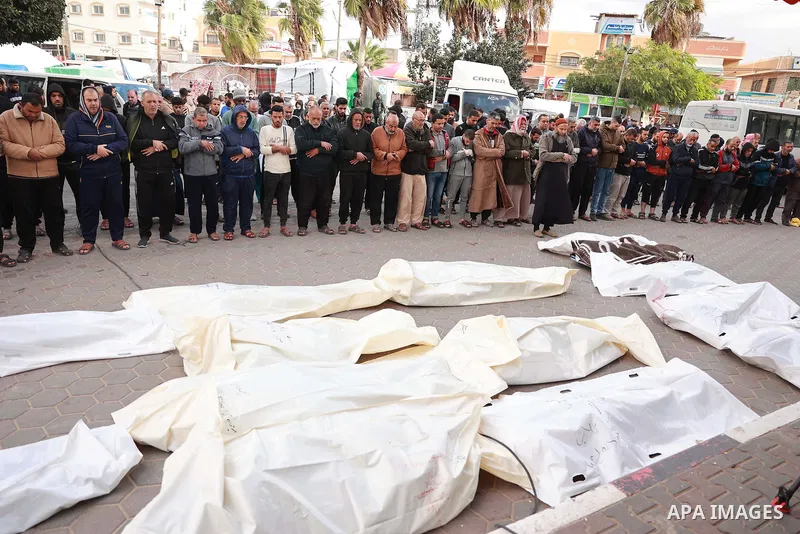 Palestinians pray during the funeral of their relatives, who were killed after an Israeli airstrike on the city of Dair El-Balah, at Al-Aqsa Hospital, on 20 November 2023.. Photo by Bashar Taleb\ apaimages