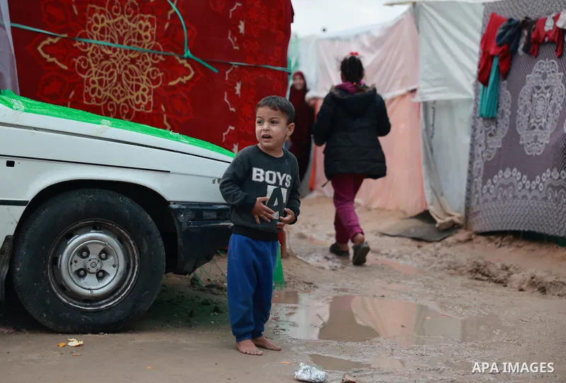 Palestinian families, who migrated to the vicinity of Al-Aqsa Martyrs Hospital due to Israeli attacks, struggle with bad weather conditions at the makeshift tents they set up in Deir Al-Balah, Gaza on November 27, 2023....