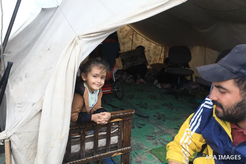 Displaced Palestinians, living in tents, struggle with cold weather under limited means and difficult conditions during the days of the humanitarian pause in Khan Yunis, Gaza on November 27, 2023. Photo by Salam Yasser\...