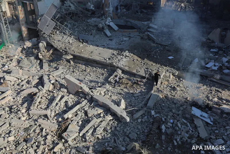 Palestinians inspect the wreckage following an Israeli air strike on the Jaffa Mosque and Hospital in Dair El-Balah, on December 8, 2023. amid continuing battles between Israel and the Palestinian militant group Hamas. F...