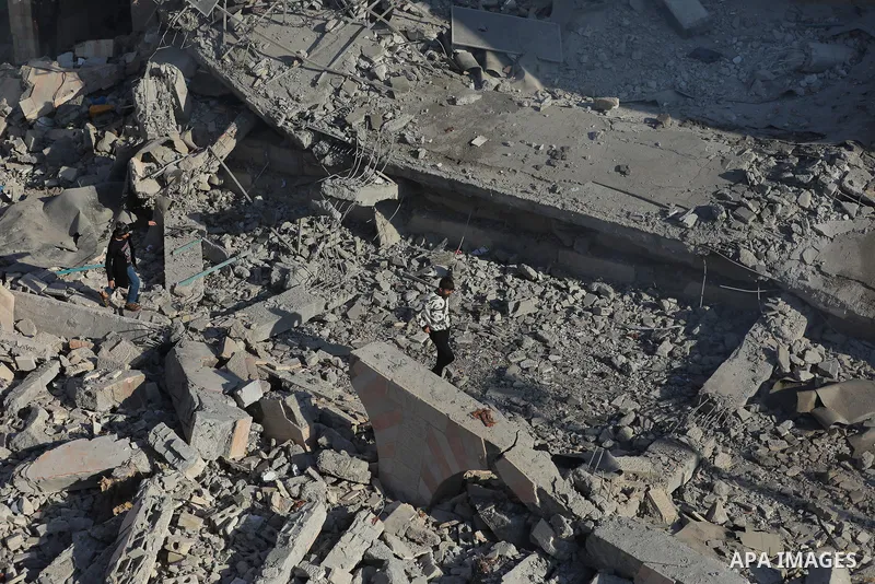 Palestinians inspect the wreckage following an Israeli air strike on the Jaffa Mosque and Hospital in Dair El-Balah, on December 8, 2023. amid continuing battles between Israel and the Palestinian militant group Hamas. F...